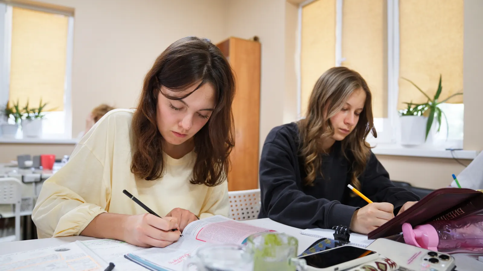 Students taking notes during a lesson